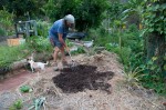 Spreading out compost to create another garden bed