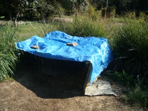 A tarp covers the grey water grease trap